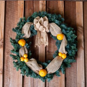 Christmas wreath hanging on wooden wall