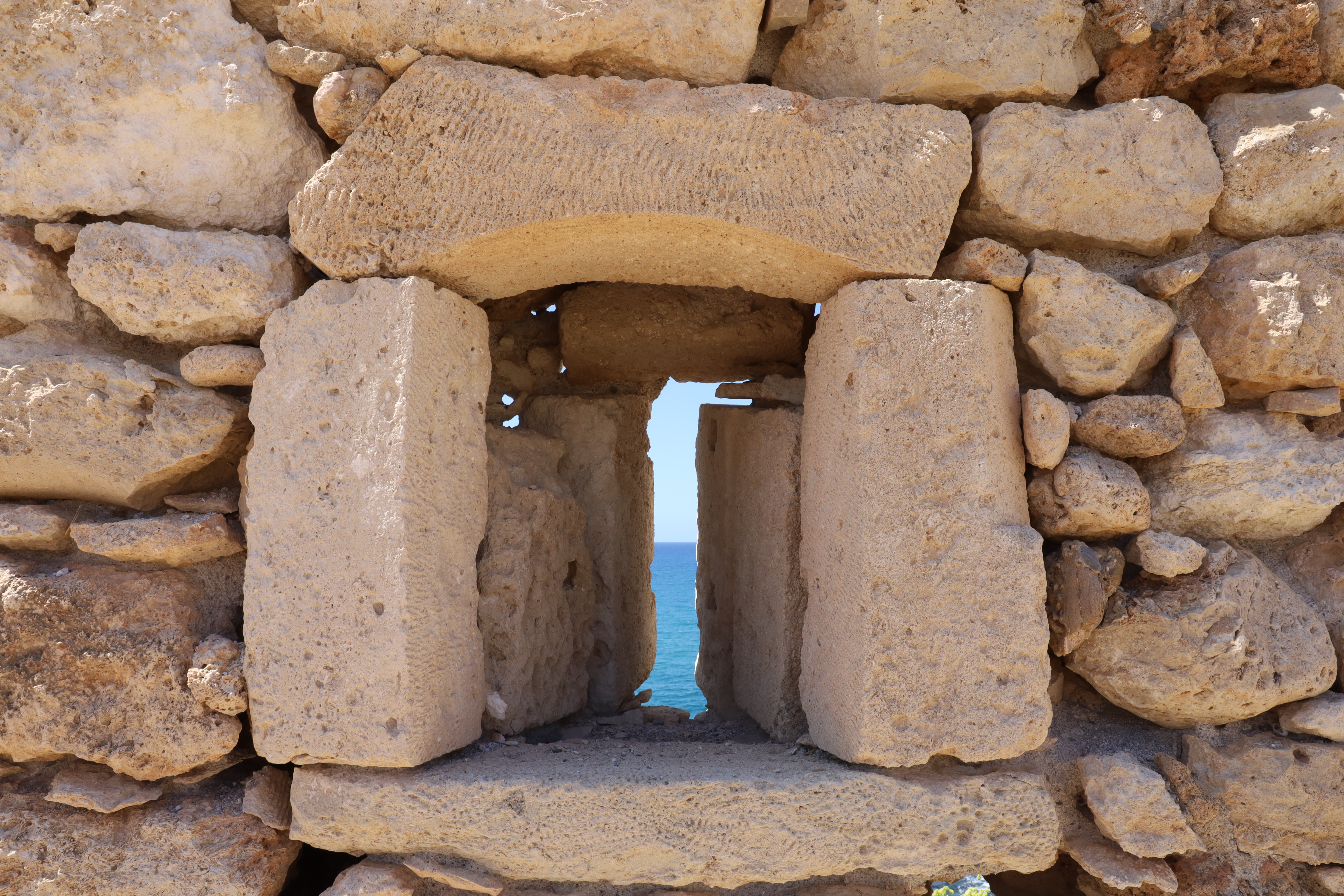 Greek architecture of a rock archway in Crete.
