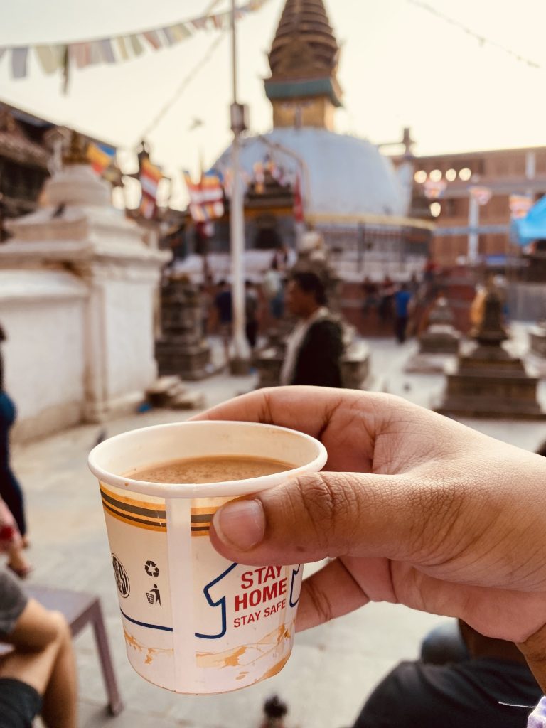 Sipping milk tea in front of a random stupa in Kathmandu, Nepal