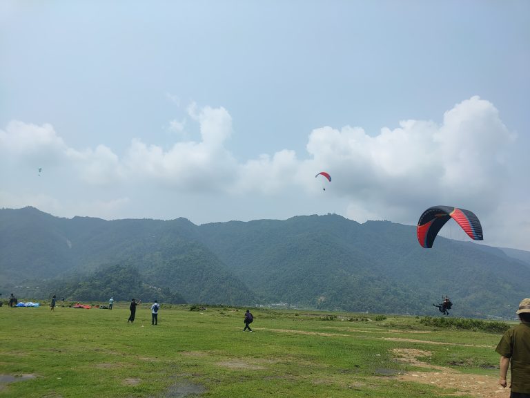 A green meadow where you will see all the parachutes land in season in Pokhara, Nepal.