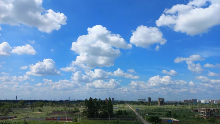 A bright sunny random Autumn day in Dhaka, Bangladesh with floating soft cottony clouds in the sky