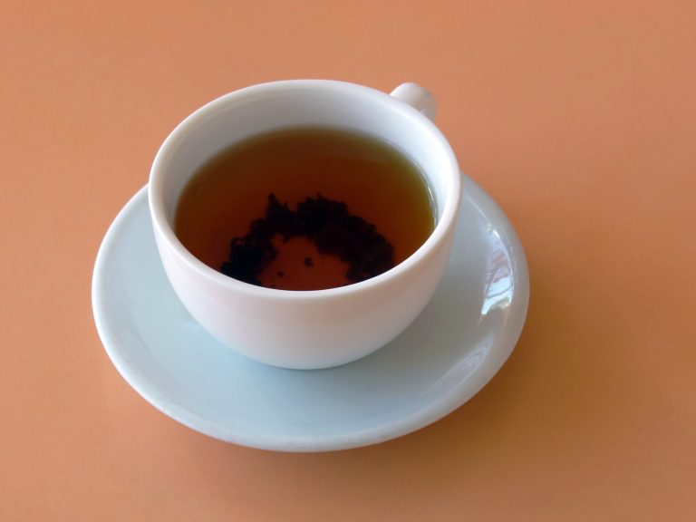 Cup of tea on a peach background (table)