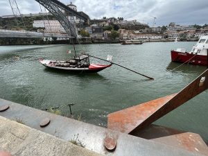 Barrel boat transporting Port win barrels on the river in Porto, Portugal.