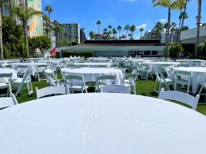 White tables set out for an outdoor event at a conference center.