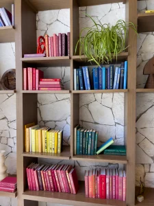 Bookshelf with books organized by color