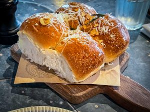 View larger photo: Dinner rolls at a restaurant on a wooden board