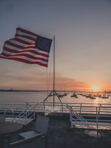 American flag on the aft the boat waving in the wind over the San Diego harbor