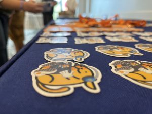 Wapuu stickers on a sponsor table at WordCamp US 2022