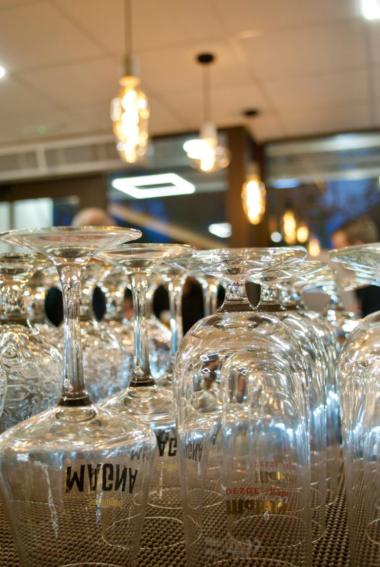 Beer glasses on a restaurant bar. Close-up with blurred background.