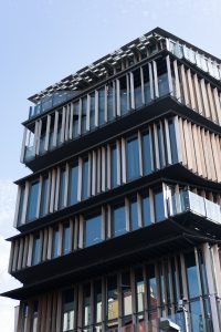 A building with wooden materials and glass
