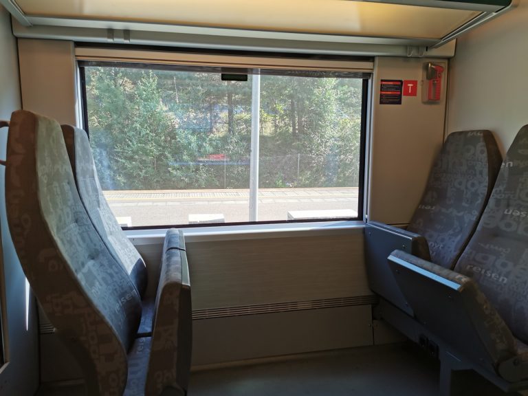 Train seats. Looking out at the platform.