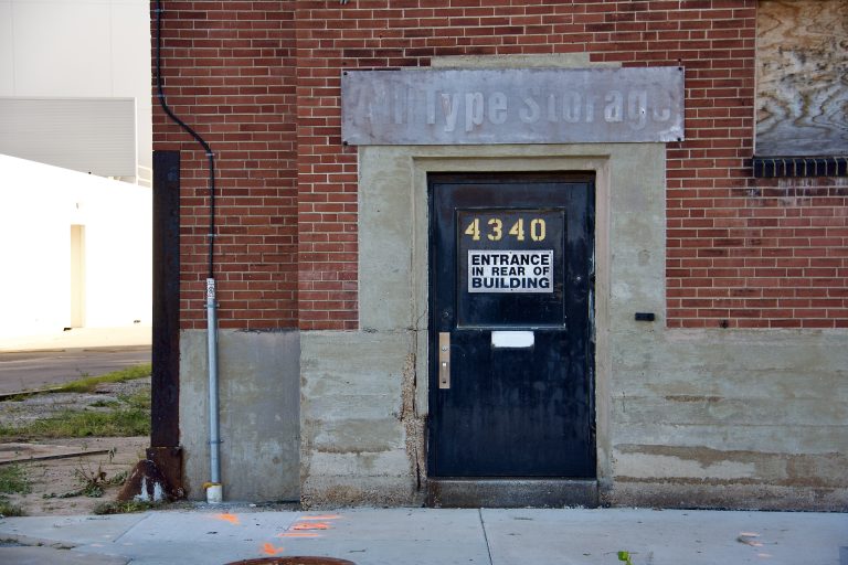 Entrance to an abandoned business in a brick building in St. Louis