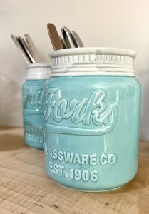 Light blue ceramic silverware canisters
