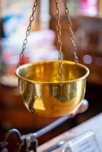 A copper weighing scale bowl