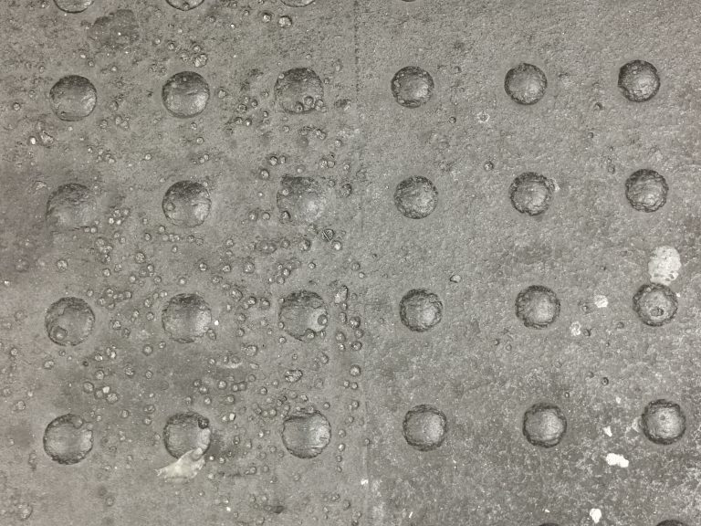 Metal plate with rivets.