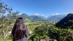 A girl enjoying the view of valley beneath the mount fishtail
