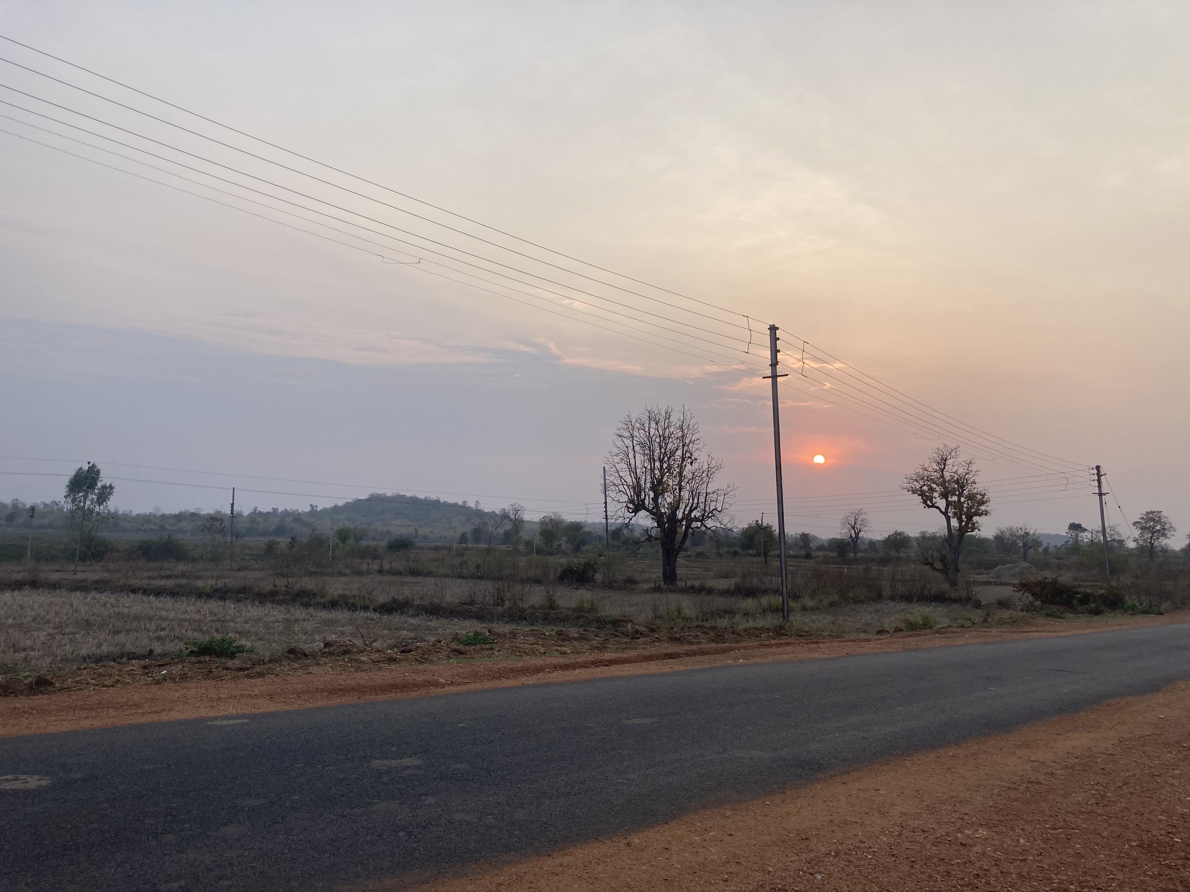 Sunset in a village after crops are cut