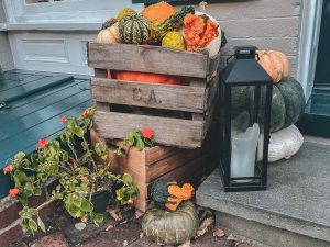 Fall decorations with small pumpkins on doorstep
