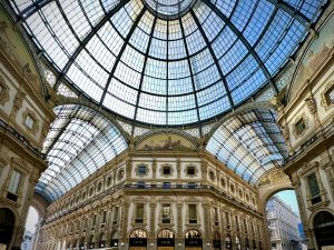 “Galleria Vittorio Emanuele II” in Milan seen from the inside of the arcade. The walls are lavishly decorated with stucco, frescoes and marble.
