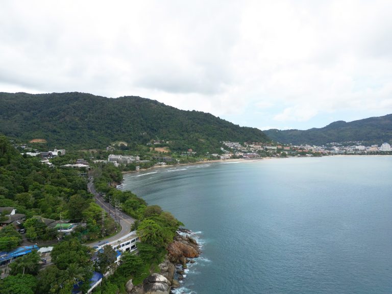 Phuket city with roads, sky, green mountain and sea in Thailand