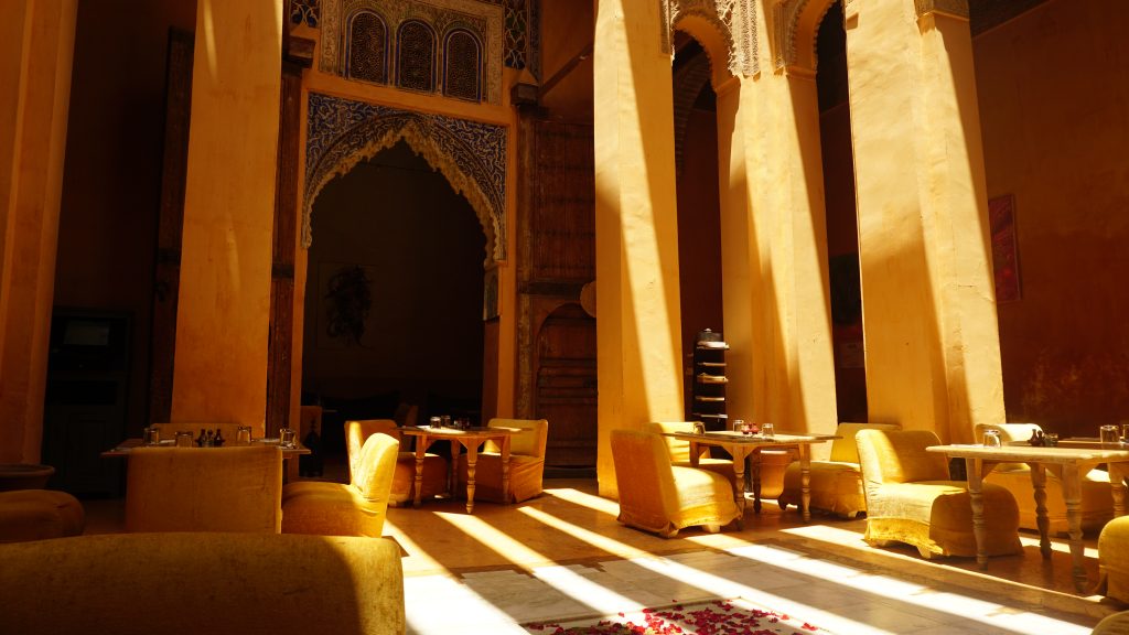 A warm interior of a cafe with sun streaming in.