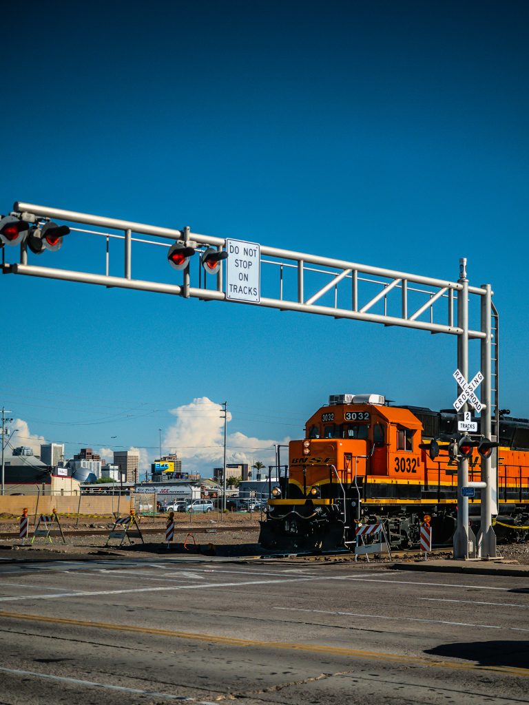 Orange Train crossing a street