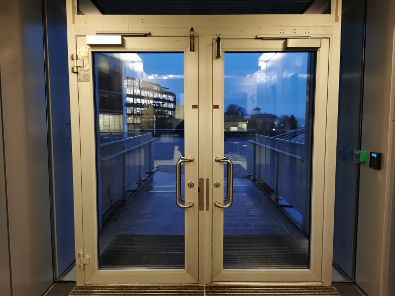 Early morning. Looking out through the entrance doors.