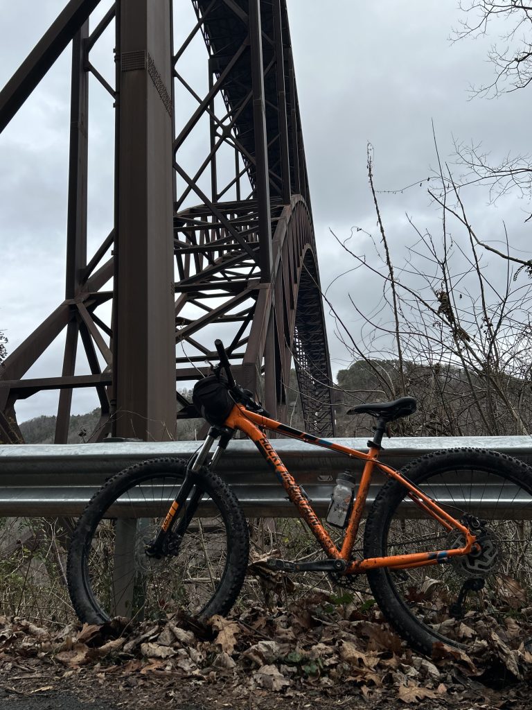 Mountain bike on Fayette Station Road, New River Gorge Bridge in the background, New River Gorge National Park, Fayette County, West Virginia