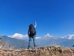A trekker enjoying the view of himalayan range.
