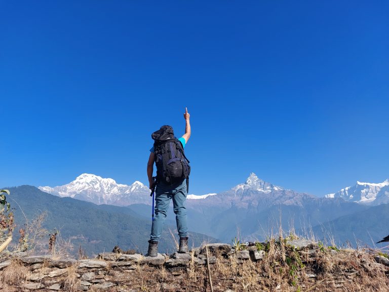 A trekker enjoying the view of himalayan range.