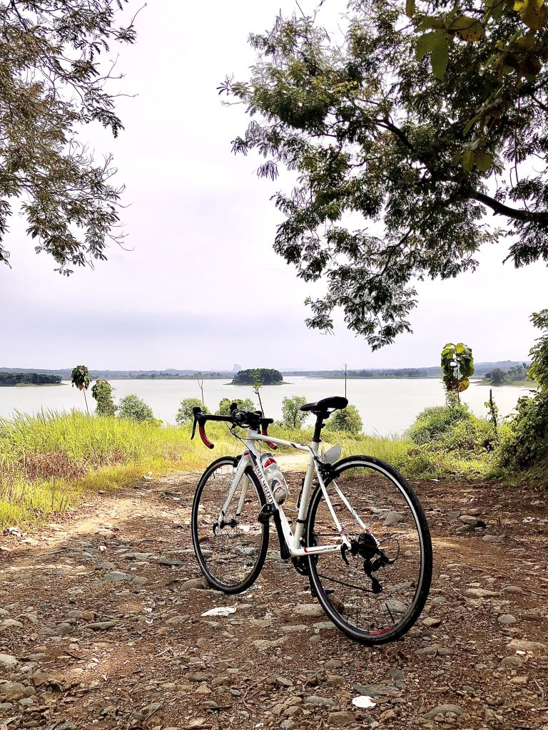 Road bike on gravel near lake