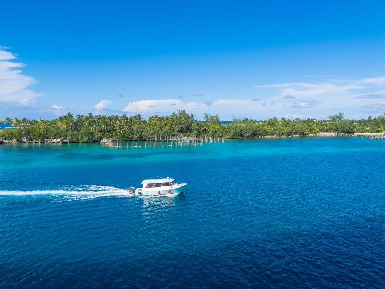 Boat in the crystal blue waters of the Port of Nassau, Bahamas