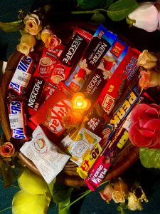 A gift basket full of chocolates and candies.
