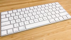 White keyboard on a bambo desktop
