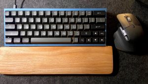 Modern Desk Setup with Tofu 60 and Logitech MX Master 3 and a wooden wrist rest

