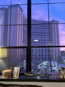 City skyline seen through large window at twilight, blue – pink sky reflected in the building

