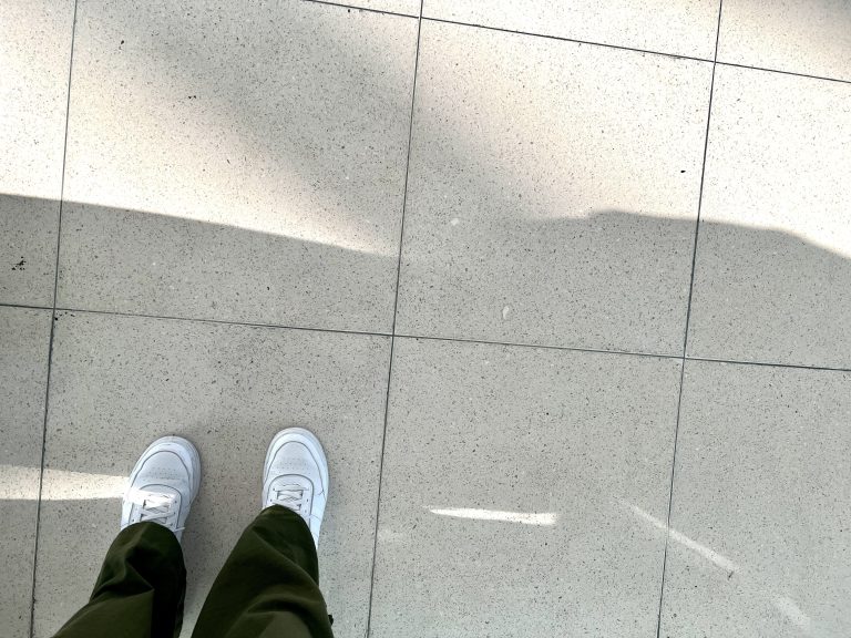 white sneakers on a tile floor