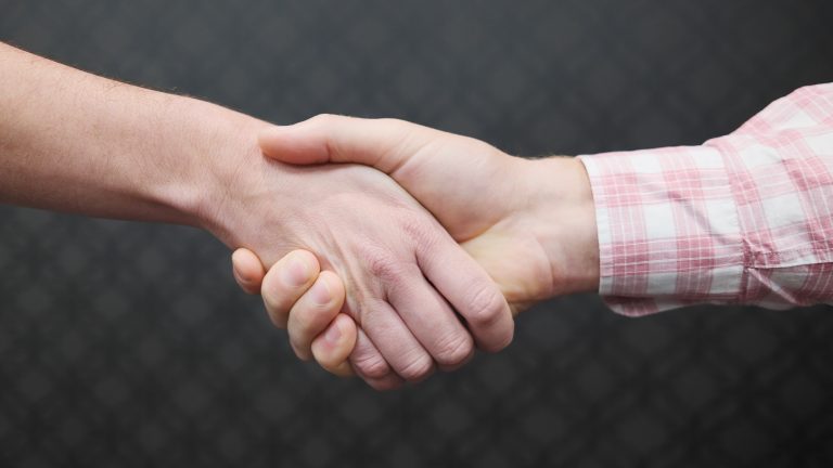 Corporate Handshake. A woman shaking a man’s hand.