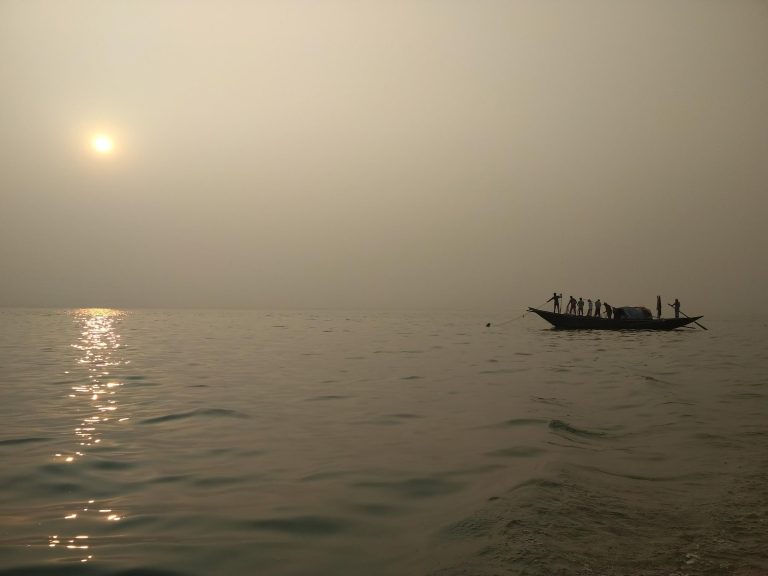 Fishing at sunset on river