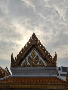 Temple top in bangkok with clouds in sky
