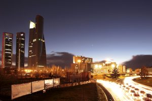 Panoramic view of a business area with tall buildings in the evening in Madrid, Spain.
