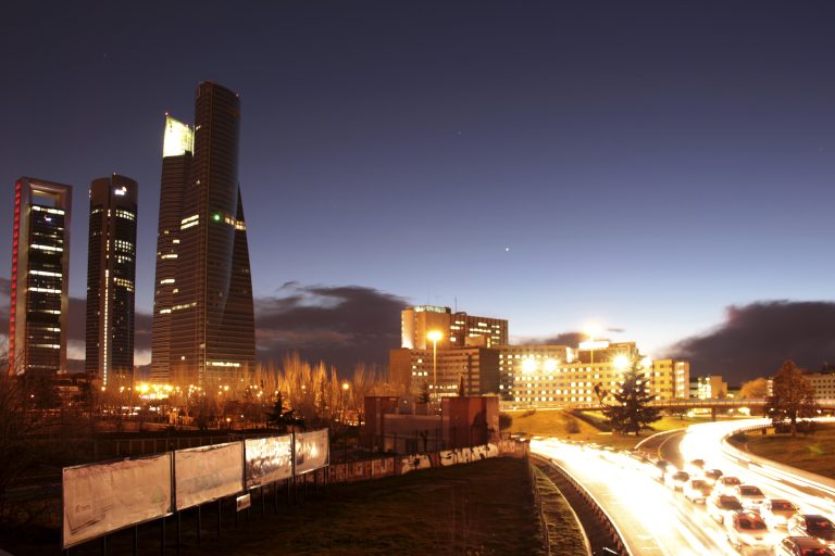 Panoramic view of a business area with tall buildings in the evening in Madrid, Spain.