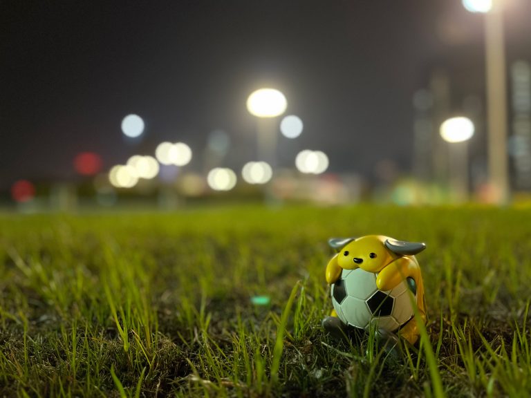 Sport Wapuu Wallpaper Collection: Wapuu playing football on the grass( 1)