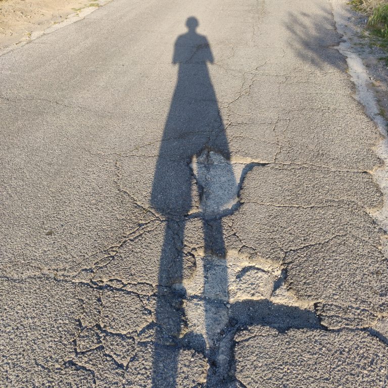 Shadow of a person on a road