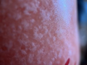 Close up ice crystals on the side of frozen cocktail glass.