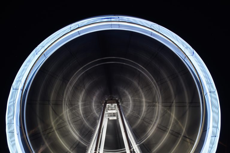 Panoramic ferris wheel at Sanlúcar de Barrameda tags: night, black, neon, amusement, movement