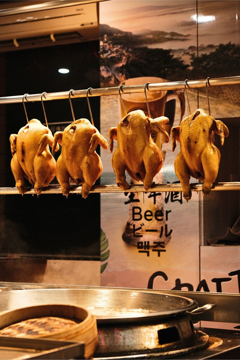 Hanging chickens that are marinated and about to be cooked in a Taiwanese restaurant