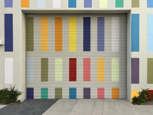 Garage door and wall with rectangles of various colors painted on them for decoration
