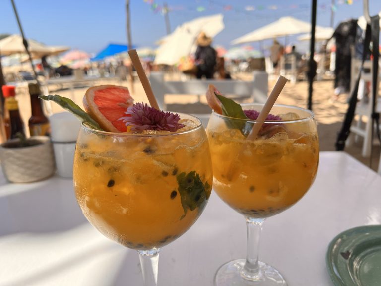 two fruity cocktail glasses on a table on a sunny day. drinks, holiday, fun, good vibes, vacation, weekend, glasses