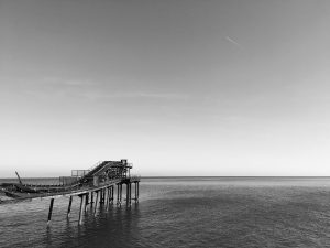 Black and white view of a pier on Rio Marina (Elba Island, Italy)
